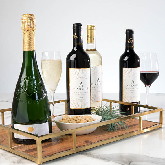 wine bottles and wine glasses on wood and copper tray