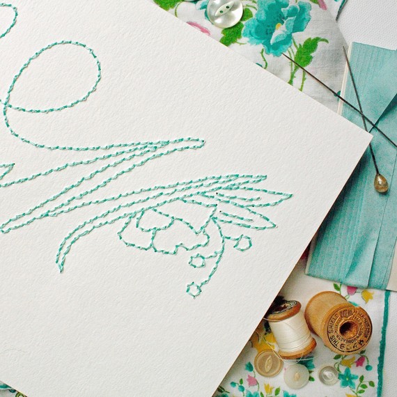 close-up of embroidered teal monogram close-up of embroidered teal monogram