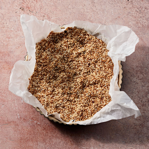 pie crust with parchment paper filled with rice and beans pie crust with parchment paper filled with rice and beans