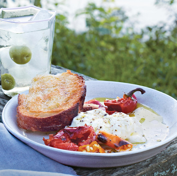 grilled bread and chiles with burrata placed on an outdoor picnic table grilled bread and chiles with burrata placed on an outdoor picnic table