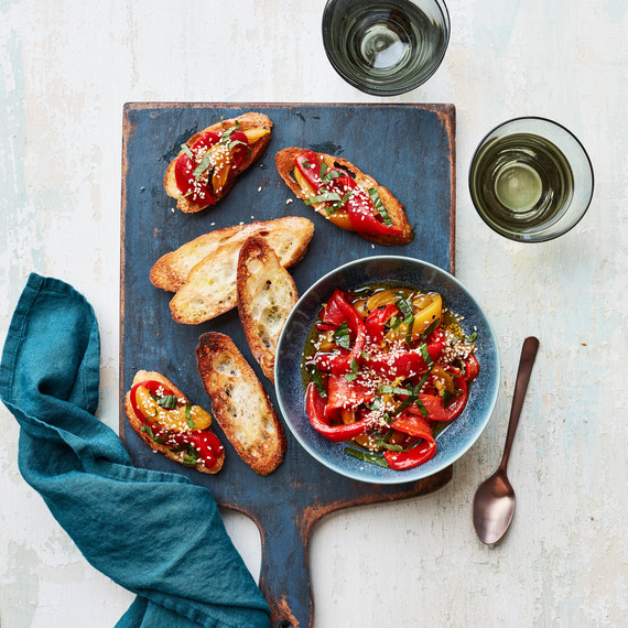 Marinated Peppers With Mint and Sesame on blue cutting board Marinated Peppers With Mint and Sesame on blue cutting board