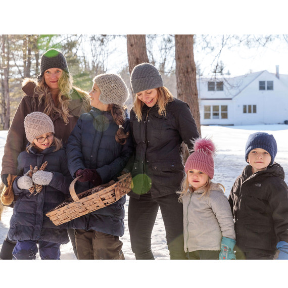 woman standing with children in snow woman standing with children in snow