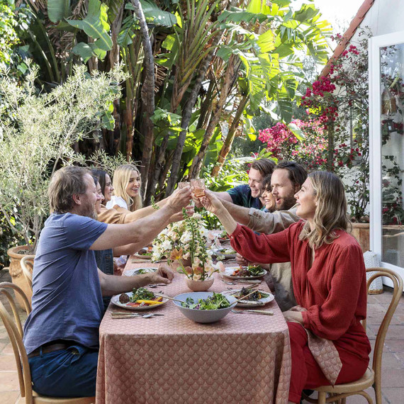 friends cheersing at an easter brunch table outside friends cheersing at an easter brunch table outside