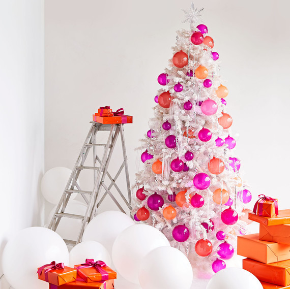 white christmas tree decorated with orange and pink handblown glass balls white christmas tree decorated with orange and pink handblown glass balls