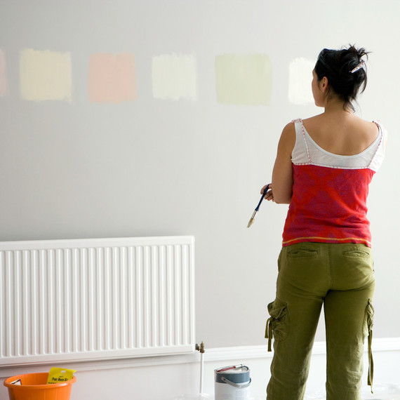 woman looking at various paint colors woman looking at various paint colors