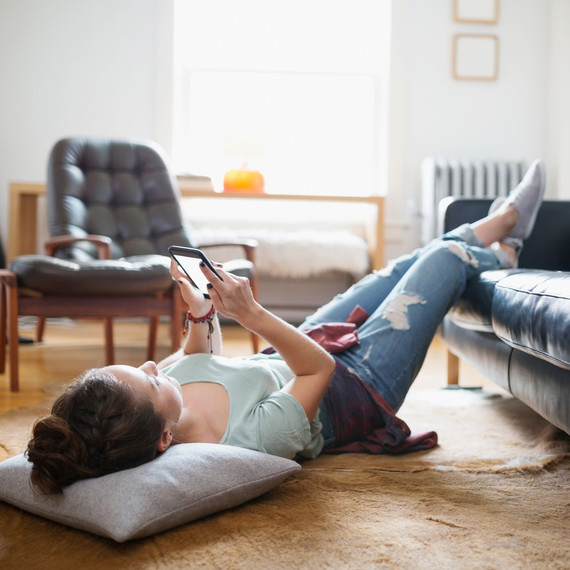 woman lying on floor with phone woman lying on floor with phone