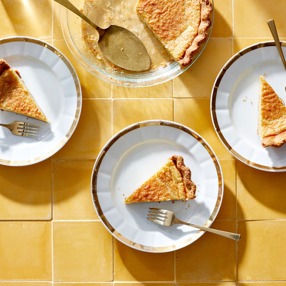 slices of buttermilk cardmom pie on gold and white plates slices of buttermilk cardmom pie on gold and white plates