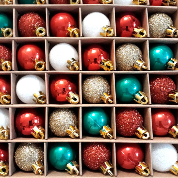green red gold and white christmas baubles on shelf green red gold and white christmas baubles on shelf