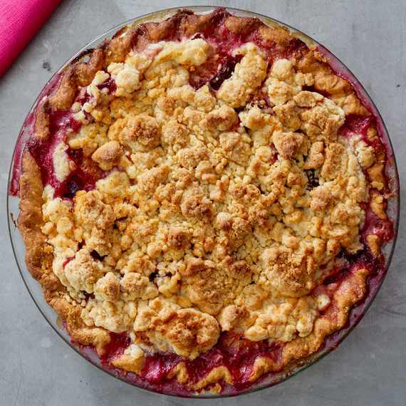 unsliced plum creme fraiche pie on a gray countertop unsliced plum creme fraiche pie on a gray countertop