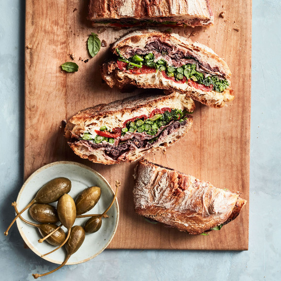 pressed sandwich with prosciutto and broccoli rabe recipe on wooden cutting board pressed sandwich with prosciutto and broccoli rabe recipe on wooden cutting board